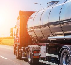 Big gas-tank goes on highway against the sky